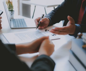 lawyer insurance broker consulting giving legal advice to couple customer about buying renting house. financial advisor with mortgage loan investment contract. realtor selling real estate